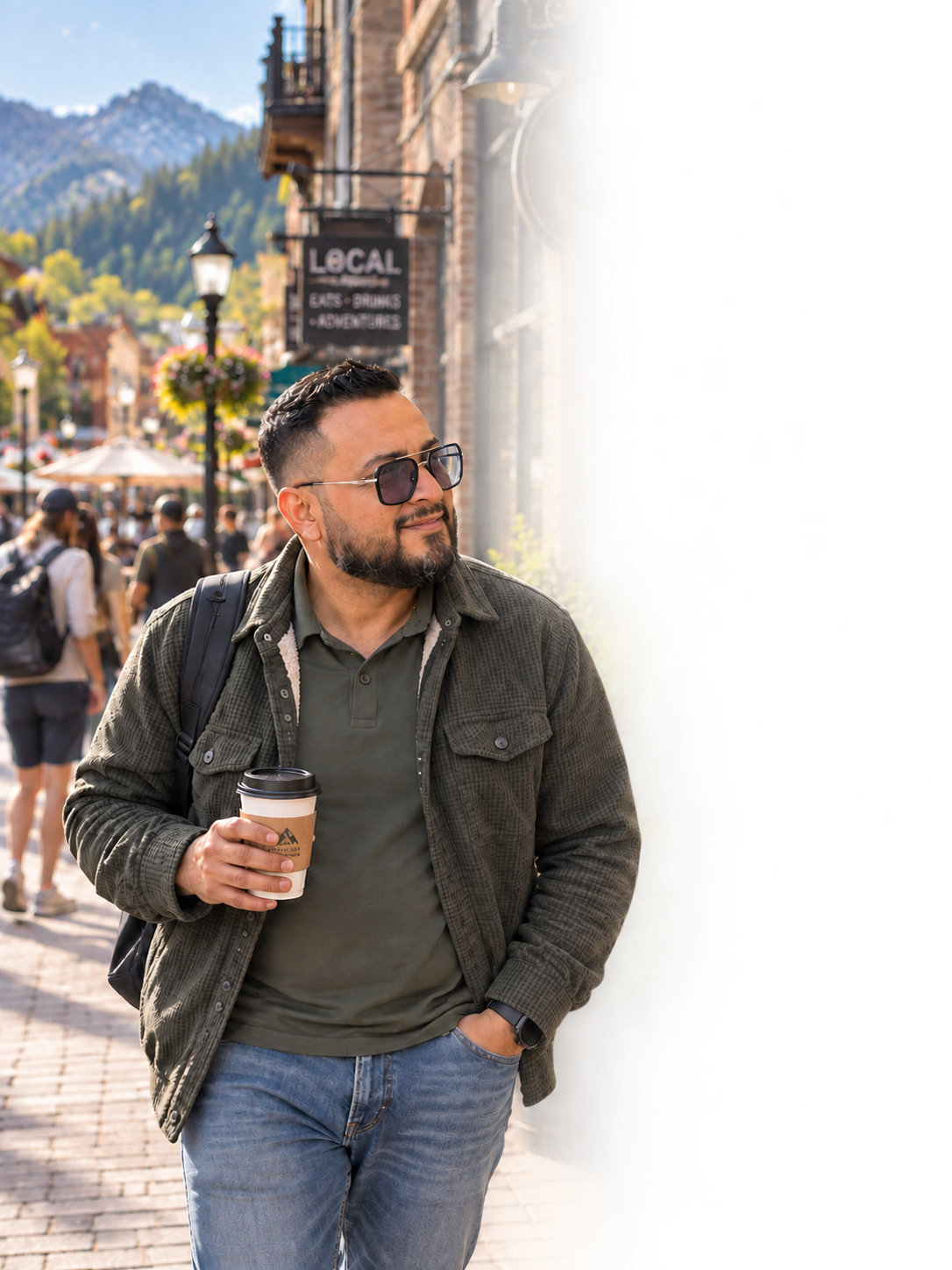 Emanuel Téllez Enríquez walking through a mountain town, coffee in hand